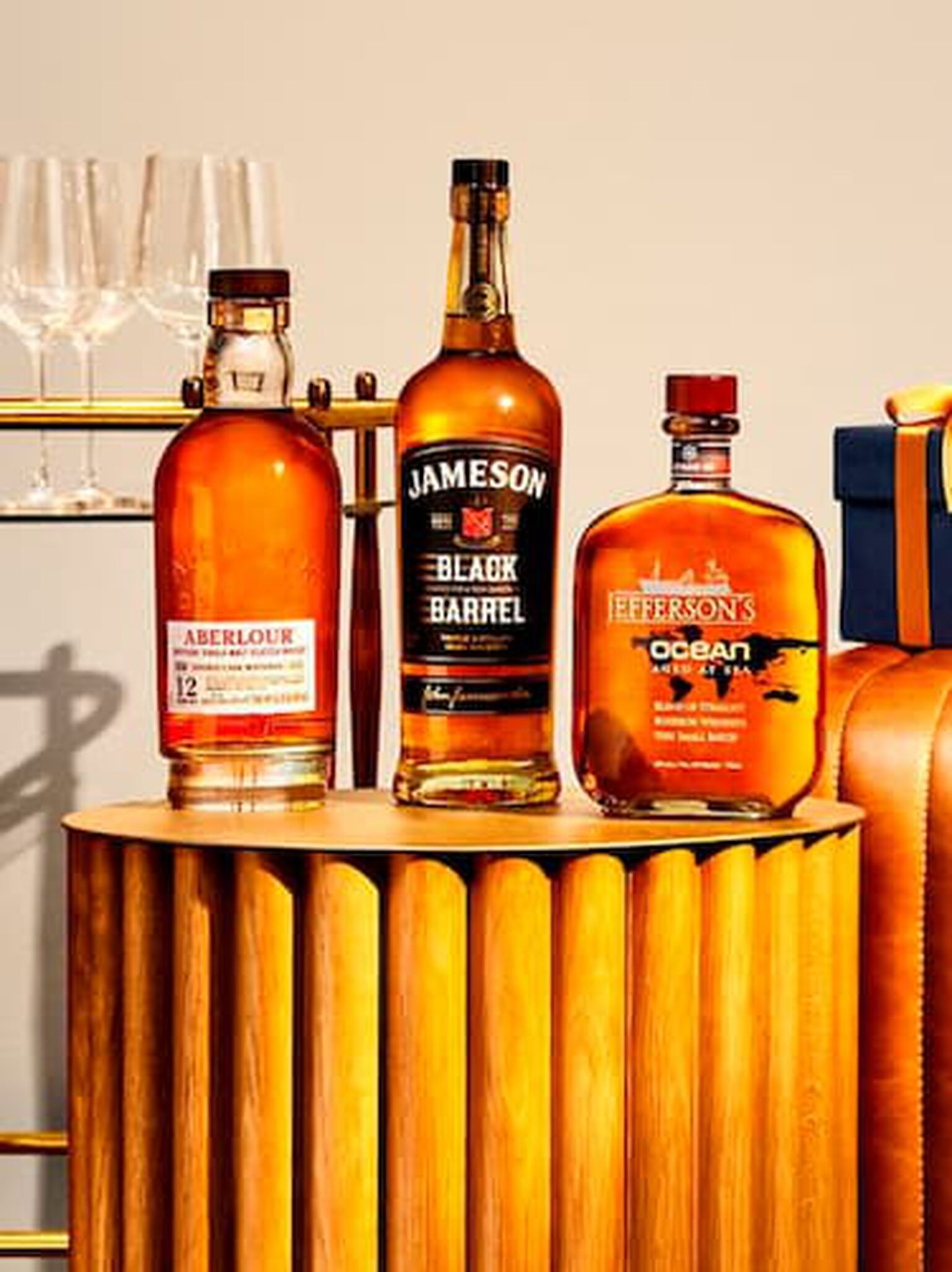 A collection of Father's Day spirits are ready to be opened on a leather couch